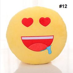 a yellow smiley face pillow with hearts on it's eyes and tongue sticking out