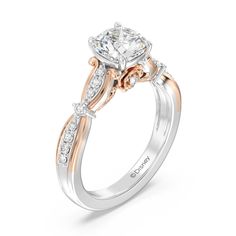 a white and rose gold engagement ring with an oval center stone surrounded by small diamonds