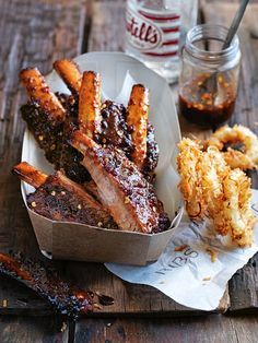 barbecue ribs and onion rings on a wooden table