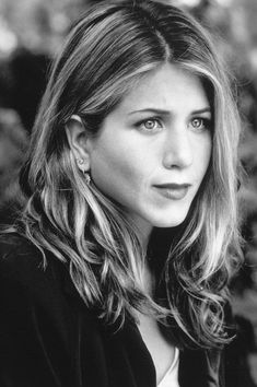 a black and white photo of a woman with shoulder length hair, wearing a jacket