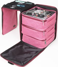 an open pink suitcase sitting on top of a white table