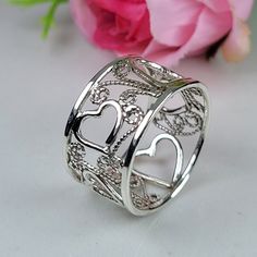 Filigree ring made in the filigree technique by intricate metal work, creating a rich floral and delicat look. The wide band ring is inspired by Boho jewelry combined with modern design. This sterling silver heart ring is perfect for a beloved woman, and as a pampering gift for yourself. The structure of the ring is approximately 12 mm wide. The ring is very flattering to the finger, comfortable to wear as a jewel for everyday use and impressive as a jewel for a special occasion. The ring is made of 925 sterling silver by hand tools only. Each piece of jewelry is handmade to order, therefor due to the special nature of handcrafting, there may be slight differences compared to the jewelry in the photos shown. This adds to the charm and individuality of each piece, making it truly one-of-a-k Unique Rings For Wedding On Valentine's Day, Elegant Ring With Artistic Design For Anniversary, Filigree Ring Jewelry Gift, Elegant Sterling Silver Ring With Artistic Design, Sterling Silver Filigree Engraved Promise Ring, Elegant Rings With Artistic Design For Gift, Silver Jewelry With Intricate Design For Valentine's Day, Bohemian Rings With Intricate Design For Promise, Hallmarked Open Filigree Promise Ring