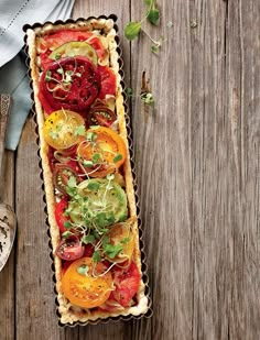 an overhead view of a vegetable tart on a wooden table