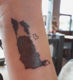 a person with a tattoo on their arm that has a dog in the shape of a heart