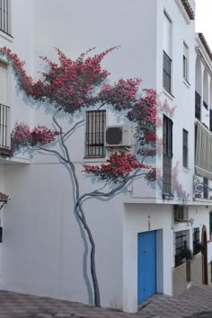 a painted tree on the side of a building