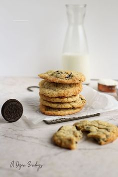 a stack of cookies next to a glass of milk