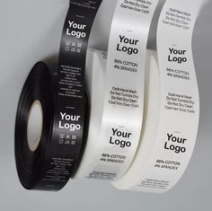 three rolls of black and white adhesives on a gray background with the words your logo printed on them