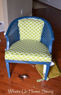 a blue chair sitting on top of a hard wood floor