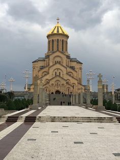 a large building with a golden dome on it's roof and steps leading up to the entrance