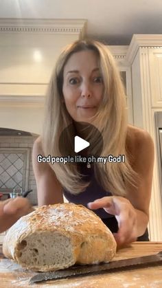 a woman standing in front of a loaf of bread