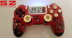 a close up of a nintendo wii game controller with red dead redemption stickers on it