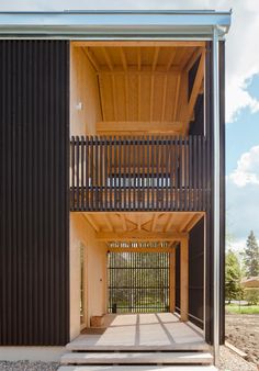 an open air building with stairs leading up to the second floor