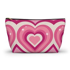 a pink and white heart shaped cosmetic bag with stars in the middle, on a white background