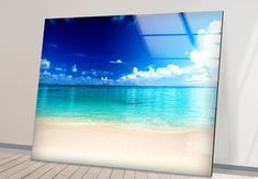 an empty room with a beach and blue sky in the background is featured on a wooden floor