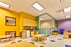 an empty classroom with tables, chairs and desks in it's center area