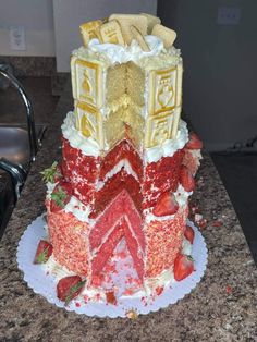 a cake that is sitting on top of a table with strawberries and other toppings