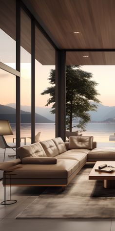 a modern living room with large windows overlooking the water and mountains in the distance is shown