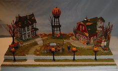 a fake halloween scene with pumpkins and houses