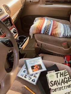 the interior of a car with books, magazines and other items sitting on the floor