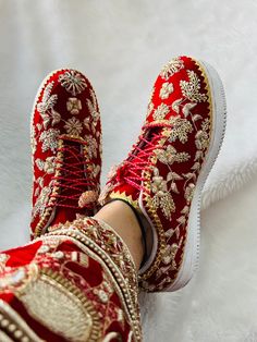 "Step into a world of elegance with our exquisite handmade bridal sneakers, meticulously crafted to add a touch of glamour to your special day. Each pair is adorned with intricate Zari work, delicate beads, lustrous pearls, and intricately woven silk threads, creating a stunning fusion of traditional craftsmanship and contemporary style. Our bridal sneakers are more than just footwear; they are a celebration of your unique style and the embodiment of timeless beauty. The Zari detailing adds a re Party Wear Shoes Women, Sneakers Bride Wedding Dress, Indian Wedding Shoes Brides, Bride Footwear Indian, Indian Shoes Women, Bridal Sneakers Indian, Traditional Wedding Shoes With Handwork For Festive Season, Bridal Footwear Indian, Indian Bridal Sneakers