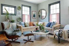 a living room filled with furniture and windows