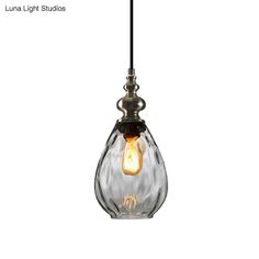 a glass light hanging from a ceiling fixture with the words luna light studios on it