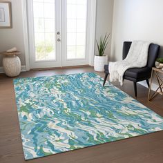 a living room with a blue and green rug on the floor next to a chair