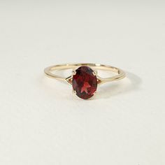 Red Garnet engagement solitaire ring, Oval cut Garnet  ring, 925 Sterling Solitaire Garnet ring, Anniversary ring/Promise ring, Gift for her Available in Sterling Silver, yellow gold plating and 14k Solid Gold  Same design can be made also with other custom gemstones and metal as per request. Product details:  Stone - Garnet Size - 6x8mm  Metal - Sterling Silver / Solid Gold Ring size - Please select your size at the drop down menu. Service Available - Customization Available with any other stones or any ideas! - FREE Worldwide Shipping, with a Tracking Number. - Custom Made To All Sizes - 2 years Warranty for any repair ( Stone replacement not included ) Free Exchange It is vital for us that you are totally happy with your purchase. If you are not 100% happy with your purchase, you can ex Red Gold Engagement Ring, Oval Garnet Ring, Timeless Oval Ruby Ring, Red Rings Engagement, Classic Marquise Jewelry For Proposal, Oval Diamond Cut Rings As Gift, Classic Marquise Ring For Proposal, Timeless Oval Ruby Promise Ring, Oval Diamond Cut Ring For Proposal