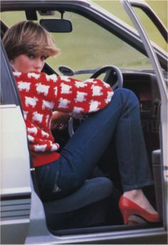 a woman sitting in the driver's seat of a car