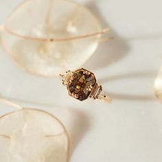 a close up view of some jewelry on a white surface