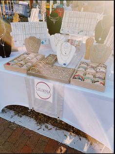 a table that has some jewelry on top of it and is set up for sale