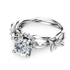 an engagement ring with a flower and leaves on the side, set in white gold