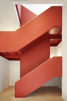 a red stair case in an empty room