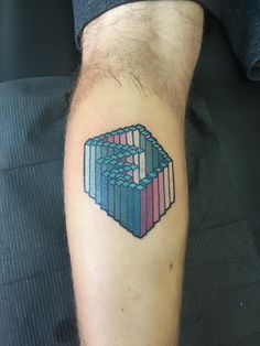 a man's arm with a colorful cube tattoo on it