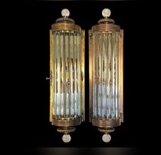 two brass wall lights with clear glass panels