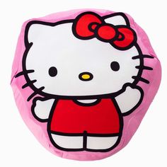 a pink hello kitty pillow with a red bow on it's head and chest