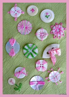 several different buttons with pink and white designs on them