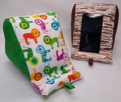 a cell phone is sitting next to an animal print pillow and holder for the phone