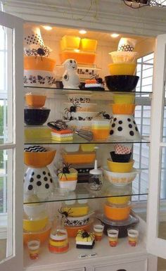 a display case filled with lots of different types of cakes and cupcakes on top of glass shelves