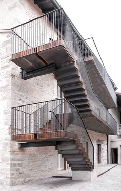 an image of a building with stairs going up to the top floor and second story