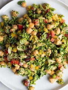 a white plate topped with broccoli and chickpeas