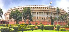 the parliament building in india is surrounded by greenery and palm trees, as well as bushes