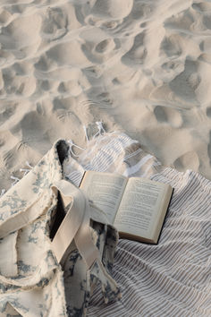 an open book laying on top of a blanket