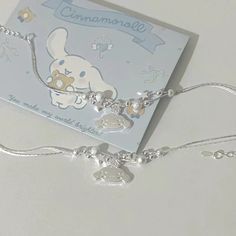 a silver bracelet with charms on it and a card attached to the clasp that says, i love you