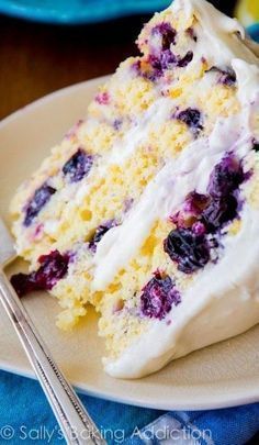 a slice of blueberry cake on a plate with a fork