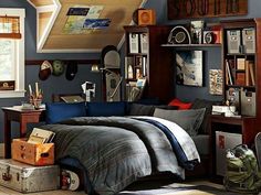 a bed room with a neatly made bed and lots of books on the shelves above it