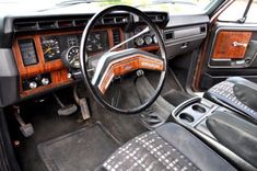 the interior of an old car with wood trims and dash board, steering wheel and dashboard