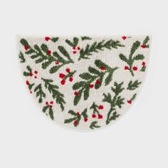 a white and green christmas decoration with holly leaves on the front, red berries on the back