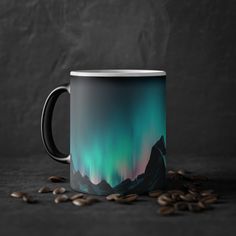 a coffee mug with the northern lights in the background and coffee beans scattered around it