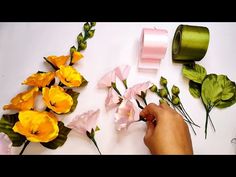 someone is making flowers out of paper and tape